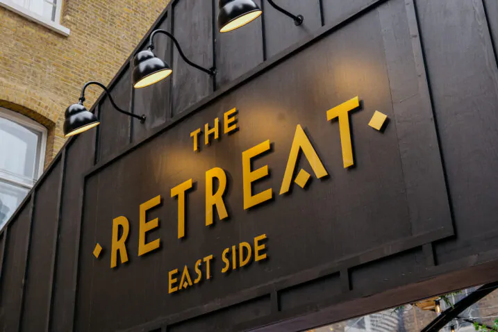 The Retreat Sign East Side