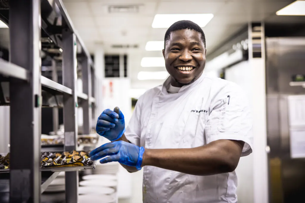 Clinton Prepping Food in the Kitchen